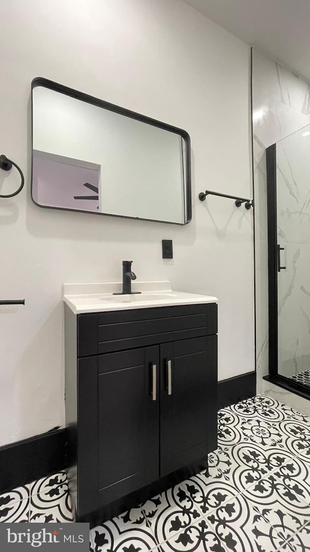 bathroom with tile patterned floors, vanity, and an enclosed shower