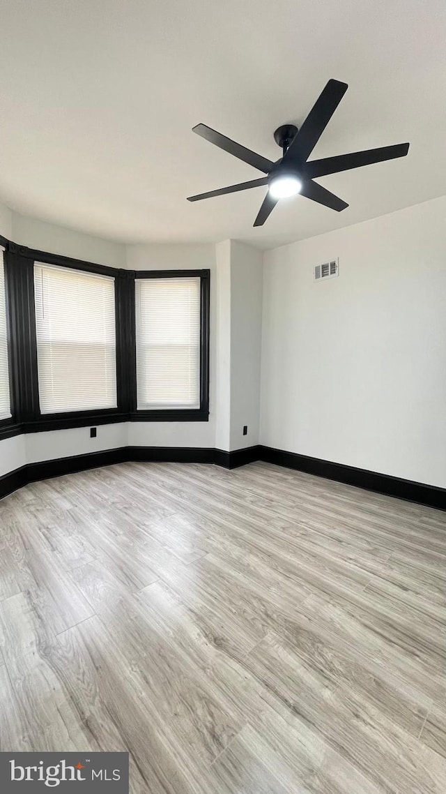 unfurnished room with ceiling fan and light hardwood / wood-style floors