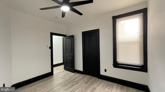 unfurnished bedroom with light hardwood / wood-style floors and ceiling fan