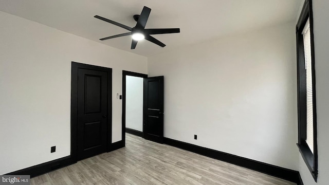 unfurnished bedroom featuring ceiling fan and light hardwood / wood-style floors