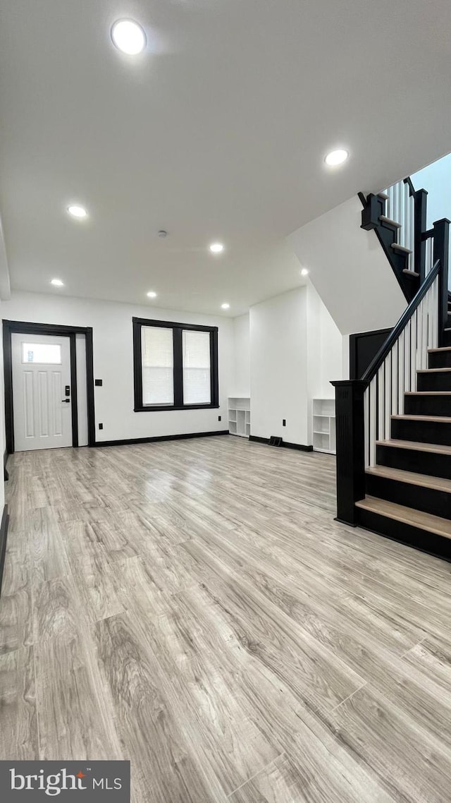 unfurnished living room with light wood-type flooring