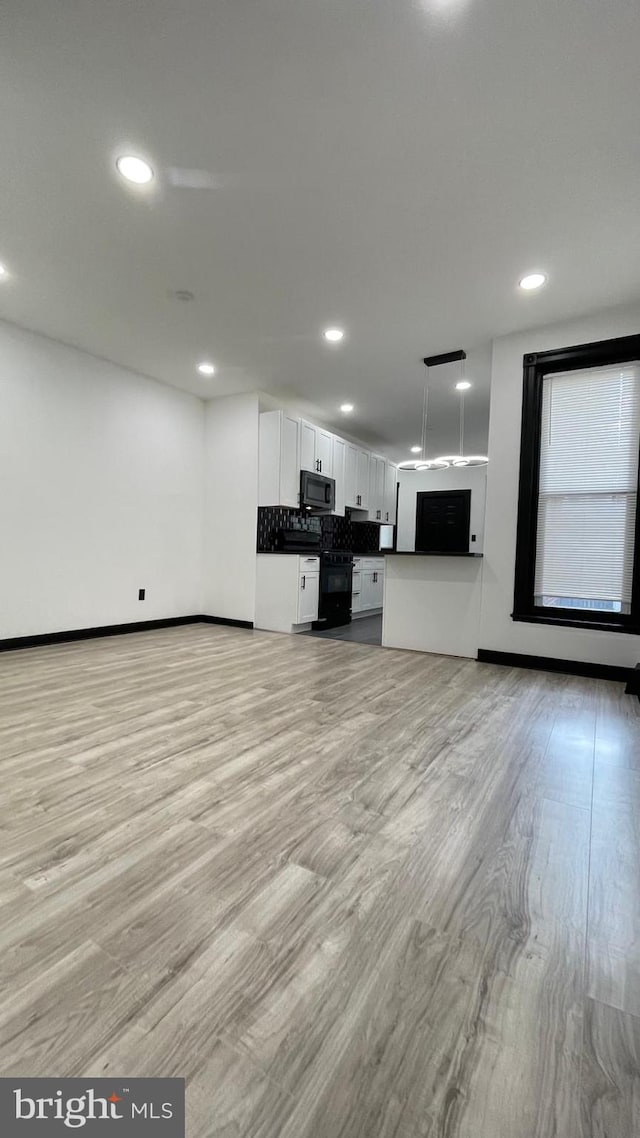 unfurnished living room with light wood-type flooring