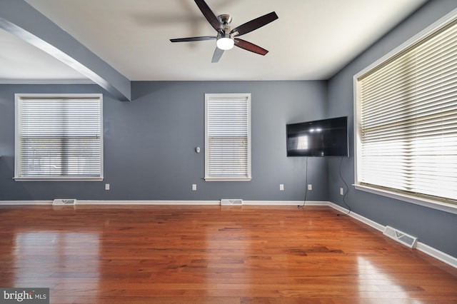 unfurnished living room with hardwood / wood-style flooring and ceiling fan