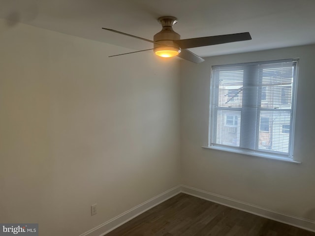 empty room featuring dark hardwood / wood-style floors and ceiling fan