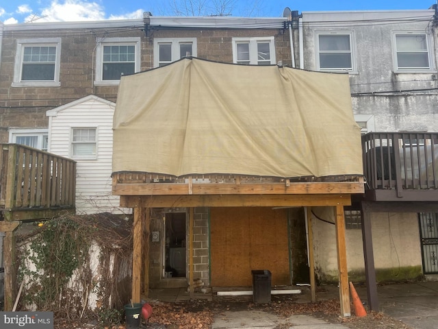 back of house with a wooden deck