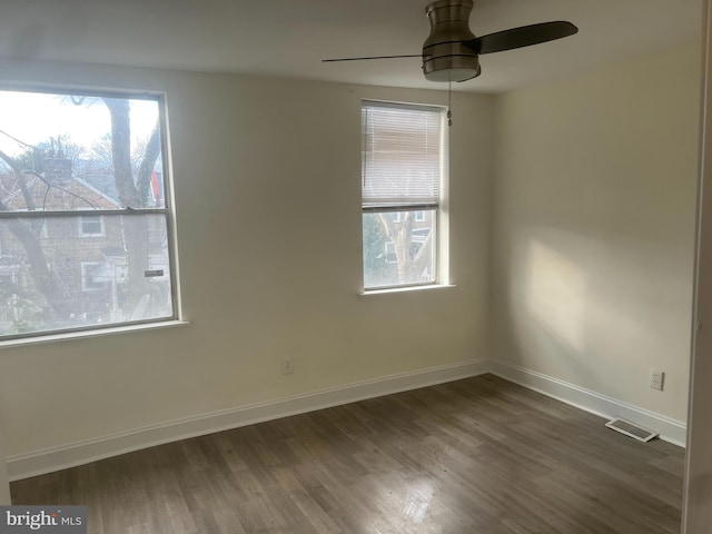 empty room featuring ceiling fan and dark hardwood / wood-style floors