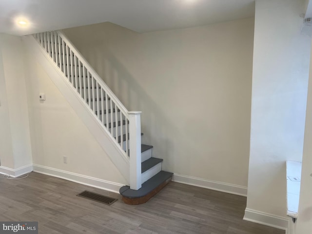 stairway featuring hardwood / wood-style flooring