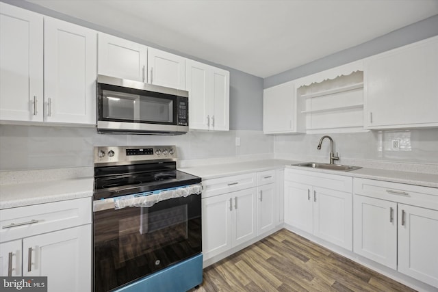 kitchen featuring white cabinets, sink, appliances with stainless steel finishes, and light hardwood / wood-style flooring