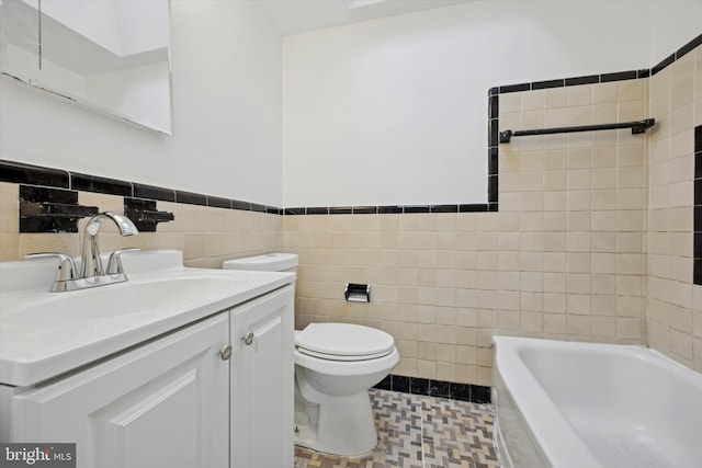 bathroom with vanity, a bath, toilet, and tile walls