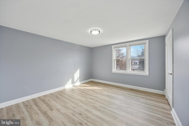 spare room featuring light wood-type flooring