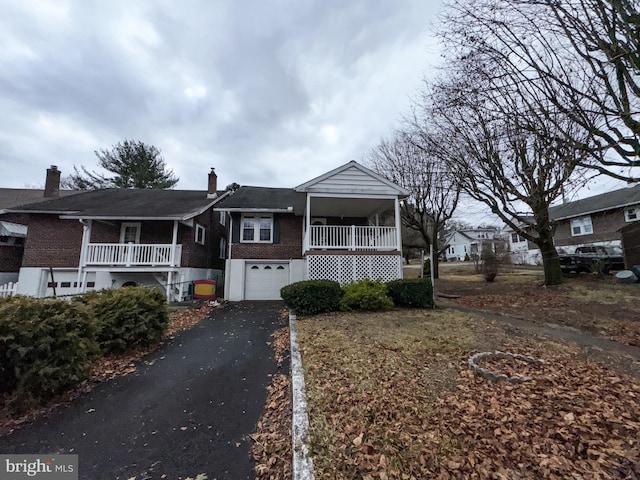 view of front of home featuring a porch and a garage