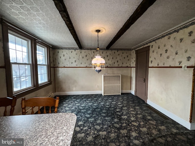 unfurnished dining area with dark colored carpet