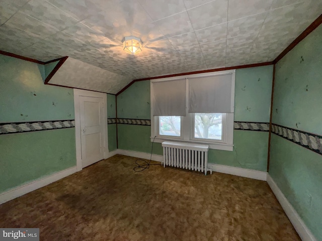 bonus room featuring carpet, radiator heating unit, and lofted ceiling