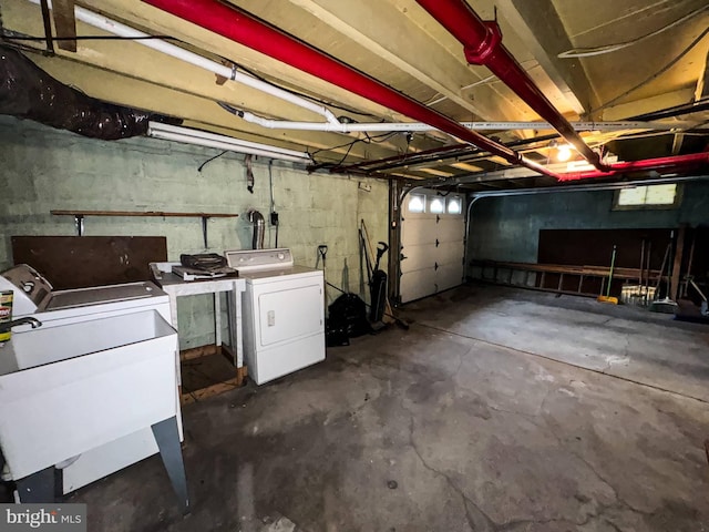 garage featuring washing machine and dryer and sink