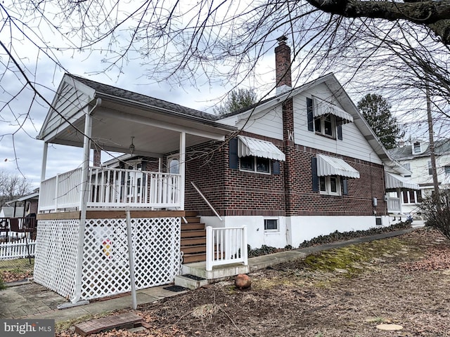 view of side of property with covered porch