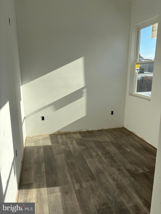 empty room with dark hardwood / wood-style flooring