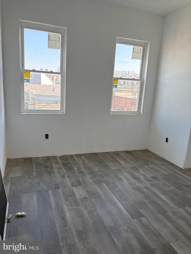 unfurnished room featuring dark hardwood / wood-style floors