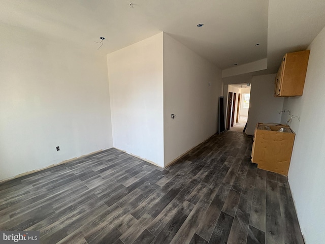 empty room with dark hardwood / wood-style flooring