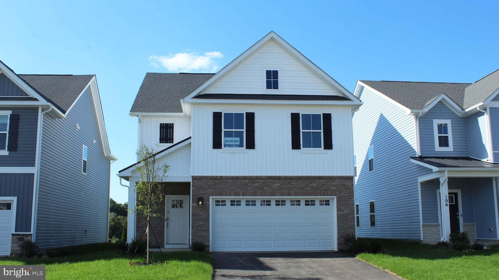 view of front of home featuring a garage and a front lawn