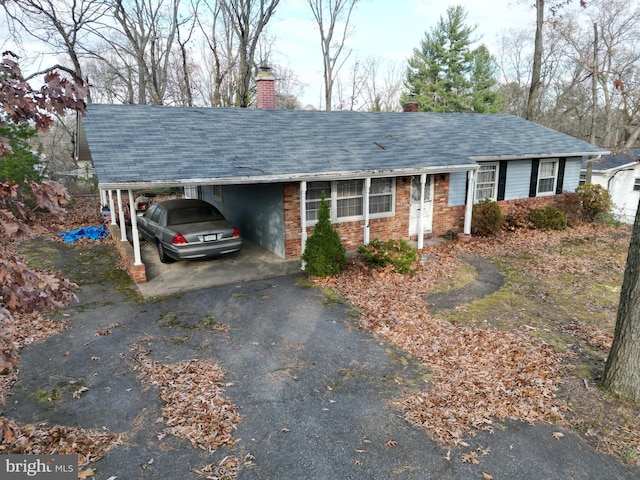 ranch-style house featuring a carport