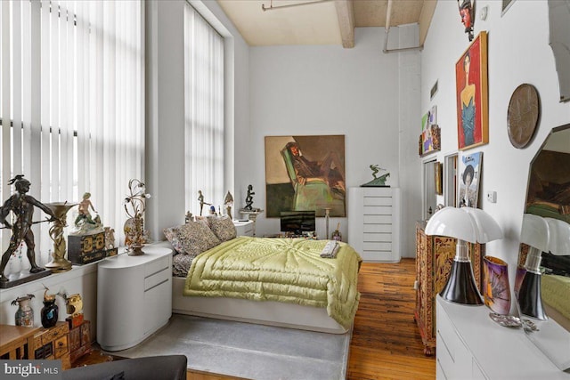 bedroom with dark hardwood / wood-style floors