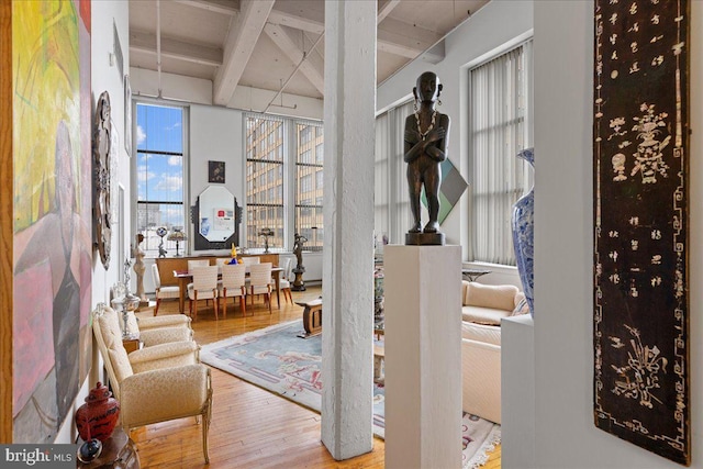 interior space with hardwood / wood-style flooring and beamed ceiling