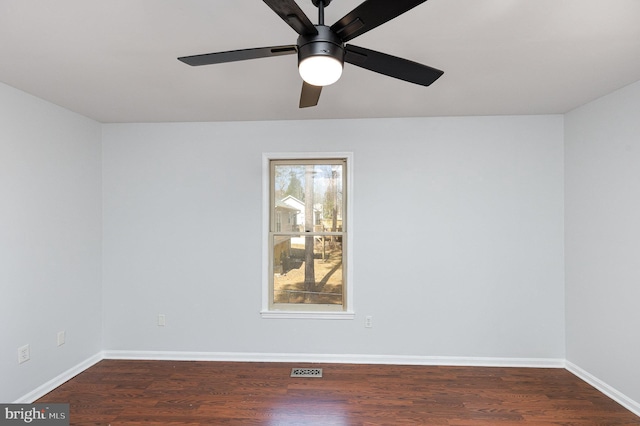 unfurnished room featuring visible vents, a ceiling fan, dark wood-type flooring, and baseboards