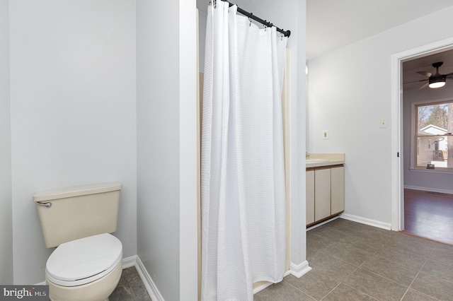 full bathroom with baseboards, toilet, vanity, and tile patterned flooring