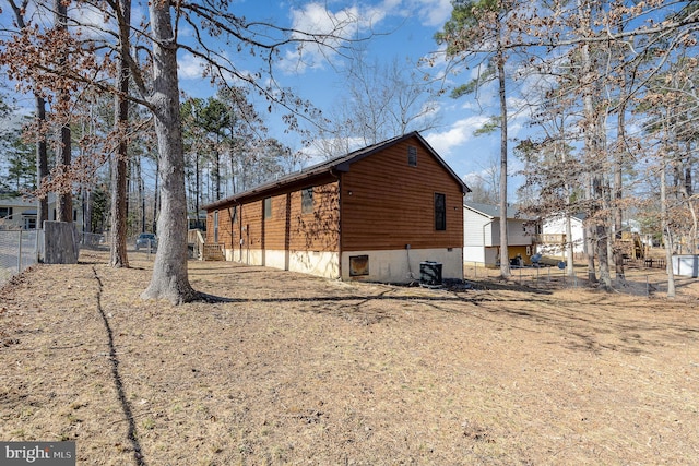 view of property exterior featuring fence