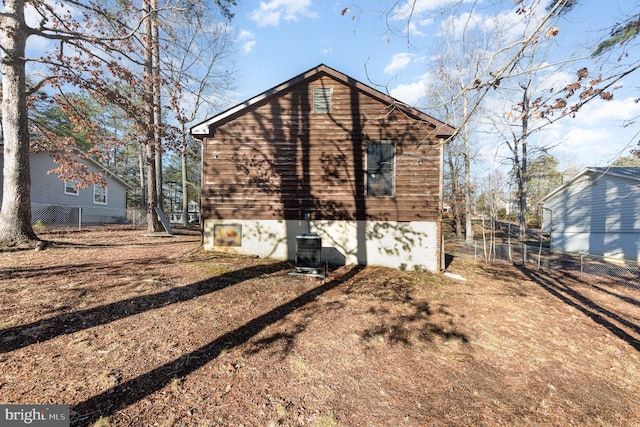 exterior space with fence and central AC