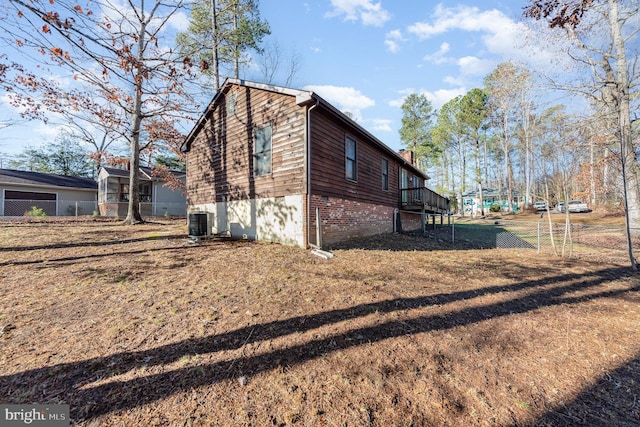 view of property exterior featuring central AC unit, a chimney, and fence