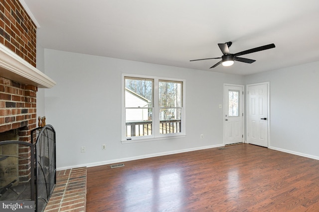 unfurnished living room featuring visible vents, ceiling fan, baseboards, a fireplace, and wood finished floors