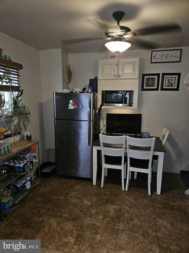 kitchen featuring ceiling fan and stainless steel refrigerator