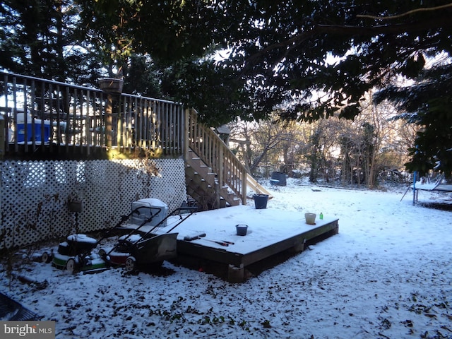 yard layered in snow featuring a deck