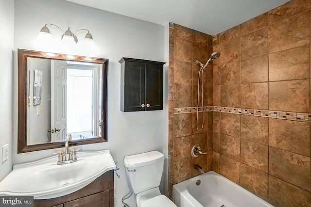 full bathroom featuring vanity, toilet, and tiled shower / bath