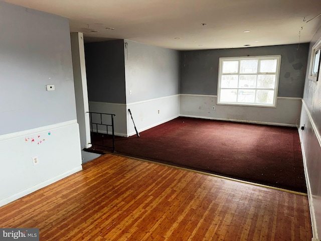 unfurnished room with wood-type flooring