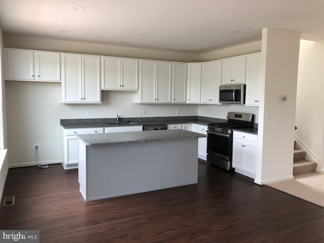 kitchen with a center island, white cabinets, and appliances with stainless steel finishes