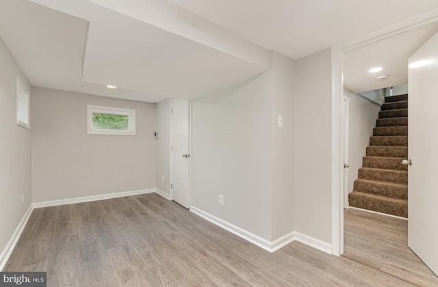 basement with light hardwood / wood-style floors