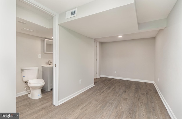 bathroom with hardwood / wood-style floors and toilet