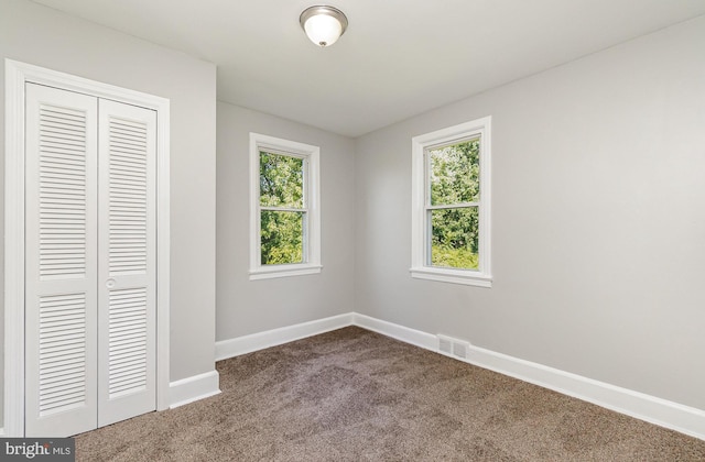 unfurnished bedroom with a closet and carpet