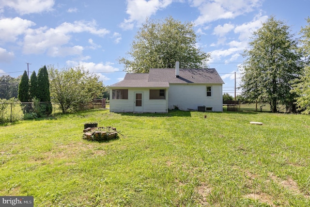 view of yard featuring central AC unit and an outdoor fire pit