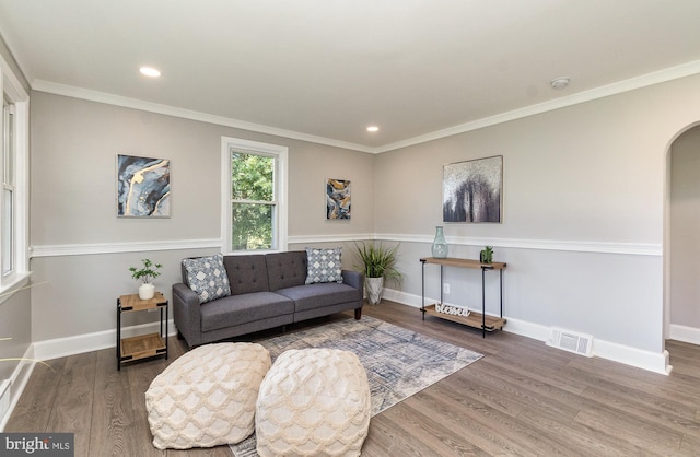 living room with ornamental molding and hardwood / wood-style flooring