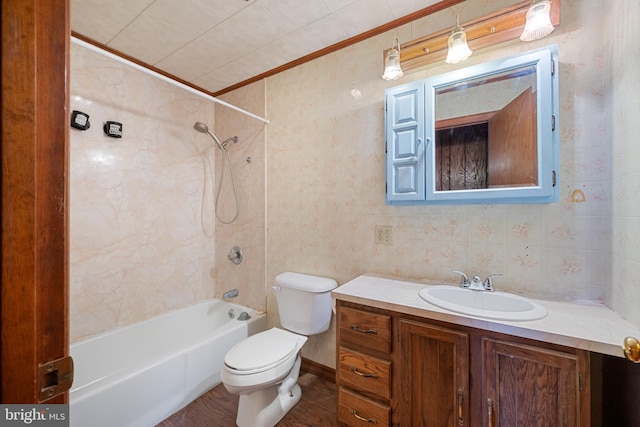 full bathroom with vanity, toilet, ornamental molding, and tiled shower / bath