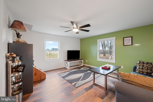 living room featuring hardwood / wood-style floors and ceiling fan