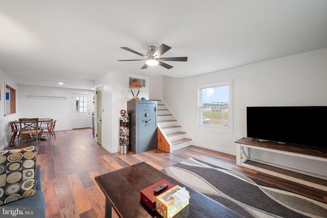 living room featuring ceiling fan and hardwood / wood-style floors