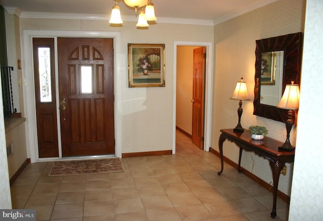 foyer entrance featuring a chandelier, tile patterned flooring, and crown molding