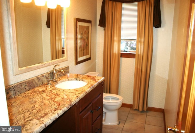 bathroom featuring toilet, vanity, and tile patterned floors