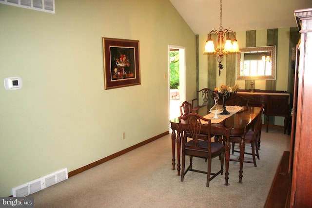 dining room with carpet flooring, vaulted ceiling, and an inviting chandelier