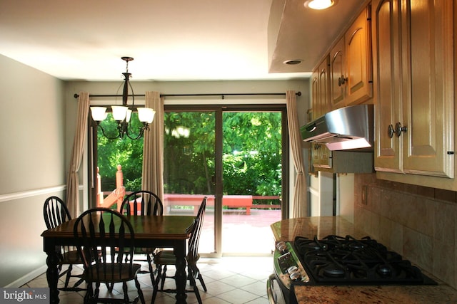 tiled dining area featuring a chandelier