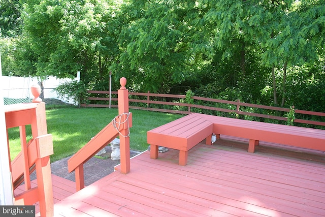 wooden deck featuring a yard